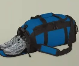 Blue duffel bag with black straps and a gray sneaker on a beige background