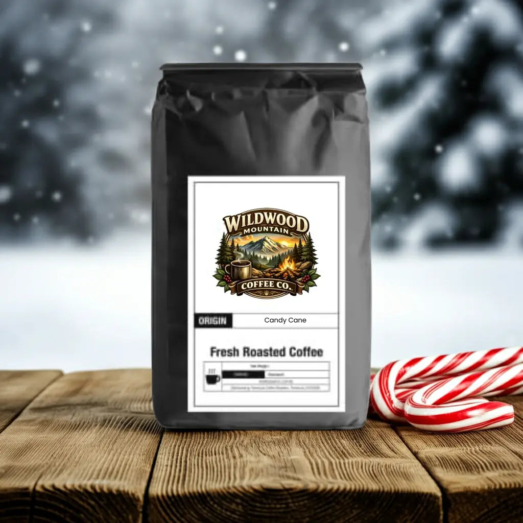Coffee bag from Wildwood Mountain Coffee Co. with candy canes on a wooden surface and snowy background