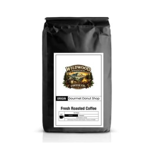 Black coffee bag with Wildwood Mountain Coffee Co. label on a white background
