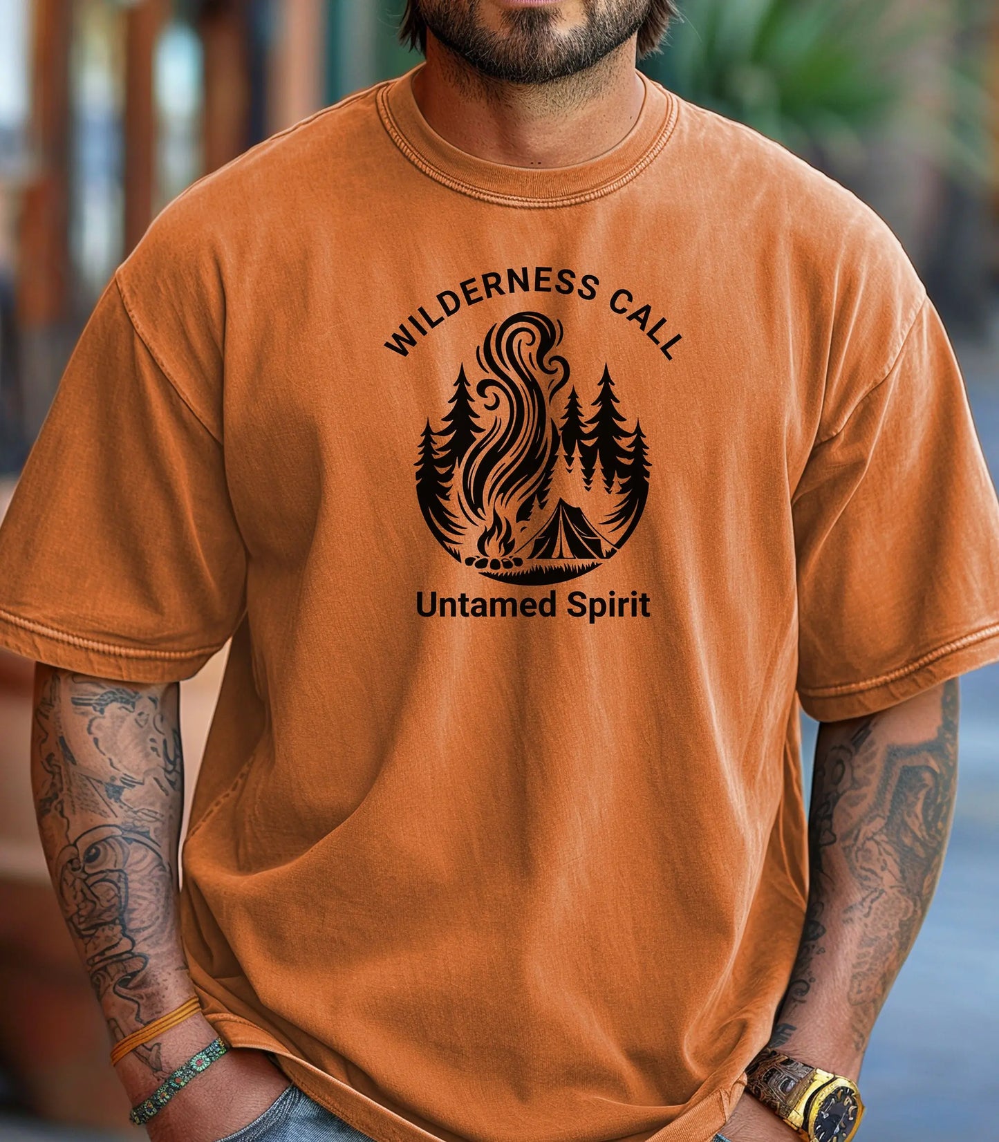 Man wearing an yam t-shirt with wilderness call untamed spirit graphic and text.