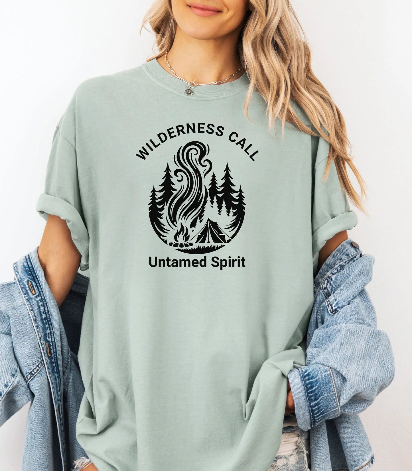 Person wearing a bay t-shirt with a 'Wilderness Call, Untamed Spirit' design