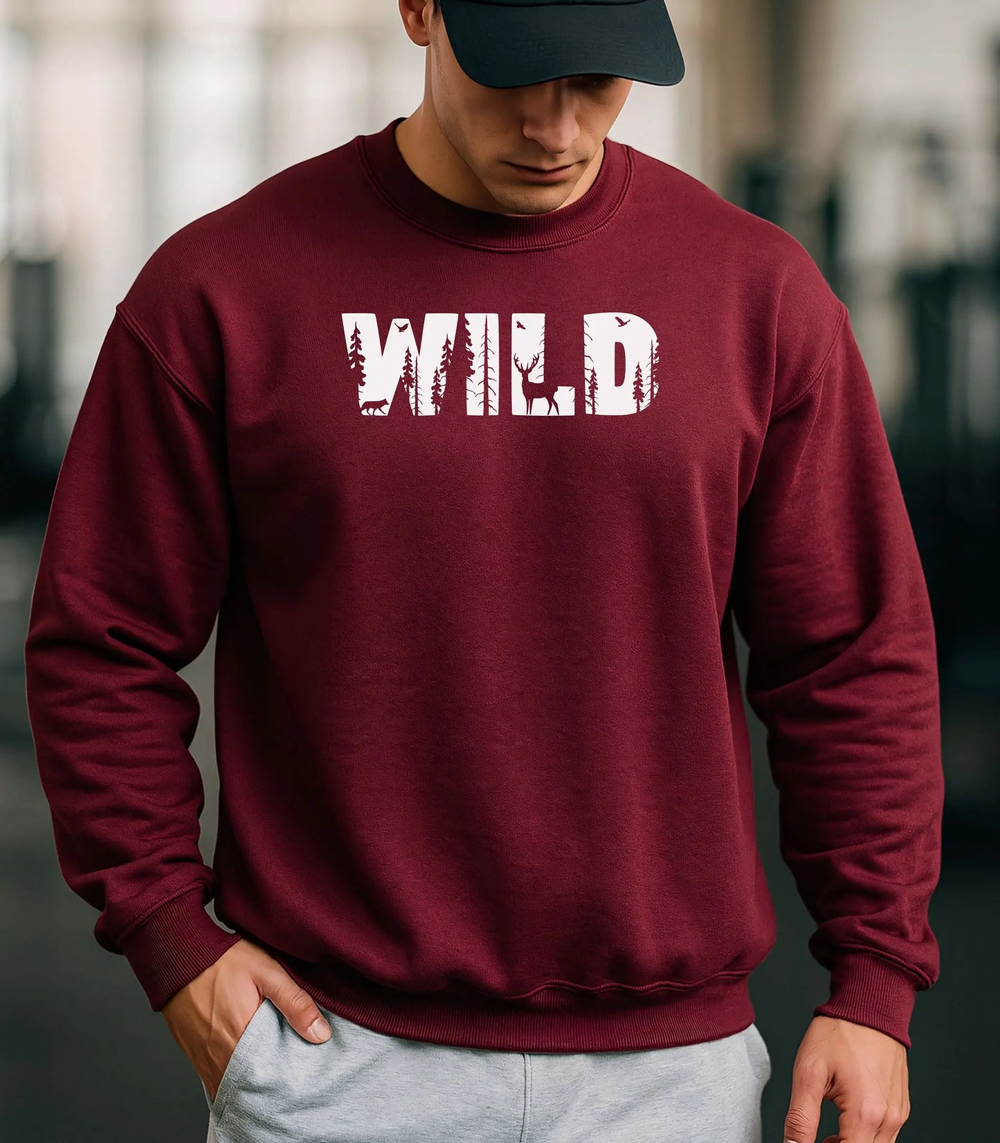 Person wearing a red sweatshirt with 'WILD' printed on it, standing outdoors.