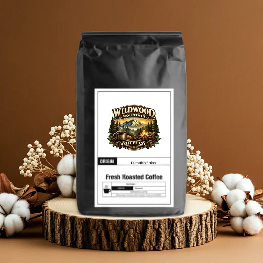 Coffee bag from Wildwood Mountain Coffee Co. on a wooden stand with decorative elements.